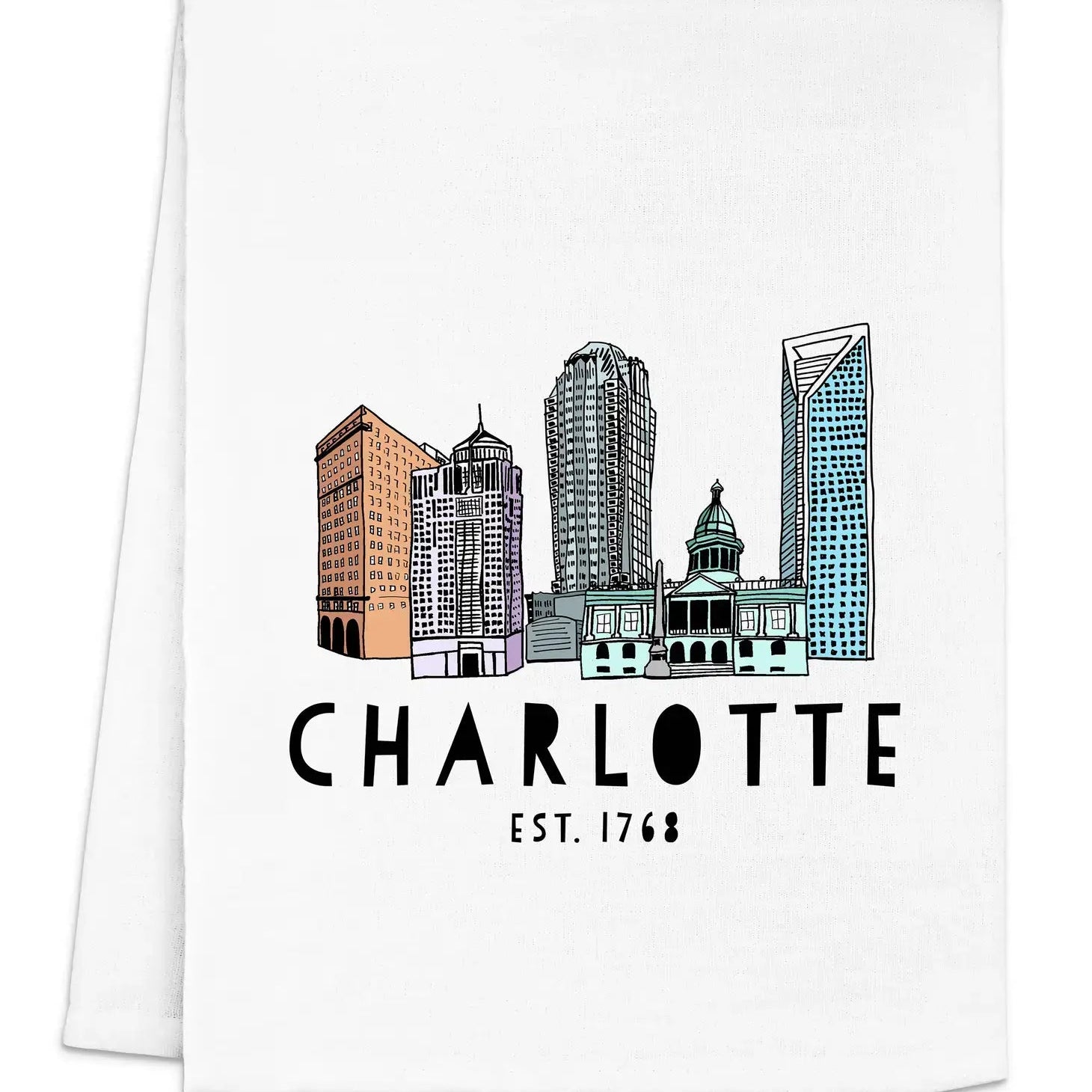 A folded white dish towel with a colorful illustration of a city skyline and the text 'CHARLOTTE EST. 1768' printed on it.