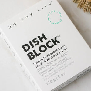 Box of Dish Block solid dishwashing soap with brushes in the background