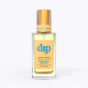 Bottle of dip coconut and almond hair and body dry oil on a white background