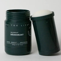 Solid deodorant stick with packaging on a white background