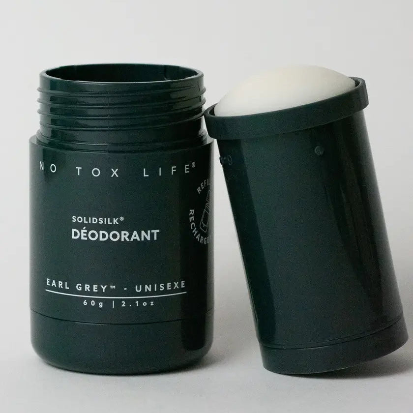 Solid deodorant stick with packaging on a white background