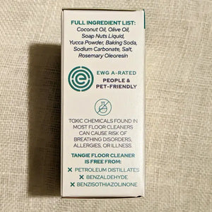 Box of Tangie Floor Cleaner with ingredient list and safety information on a textured beige background