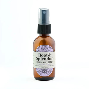 An amber glass room and body spray bottle with a black spray cap and a cream label reading 'Root & Splendor' on a white background.