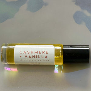 Small bottle of 'Cashmere + Vanilla' perfume on a light background