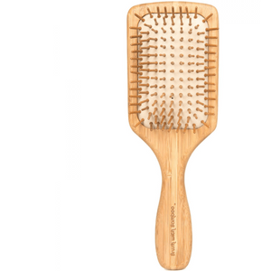 Wooden paddle brush on a white background
