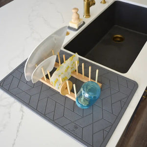 Diatomite drying mat next to a kitchen sink