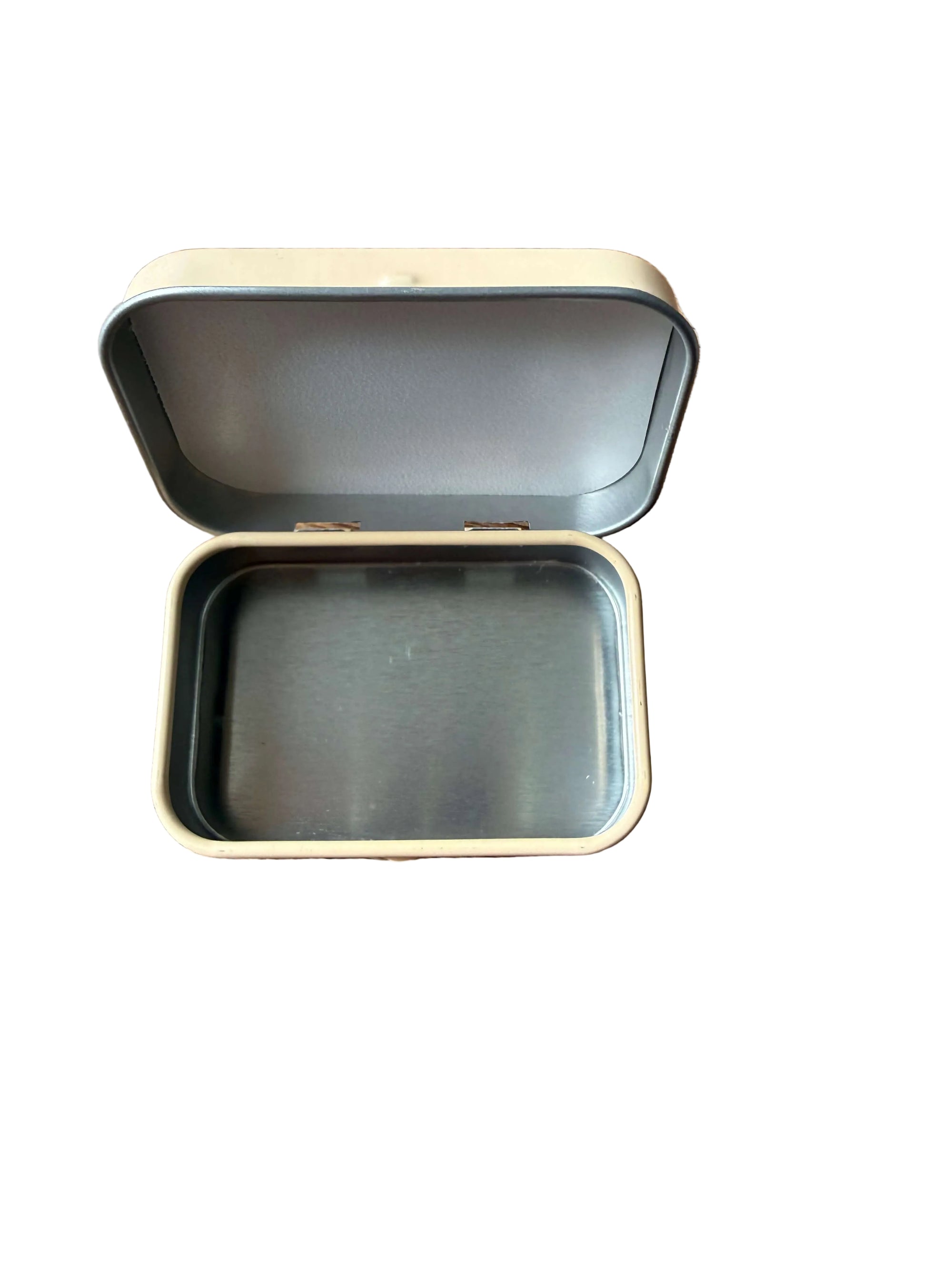 Open metal tin on a wooden surface