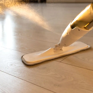 Floor cleaner with mop head on a wooden floor
