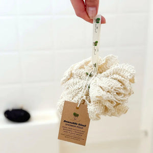 Reusable loofah with a tag on a white background