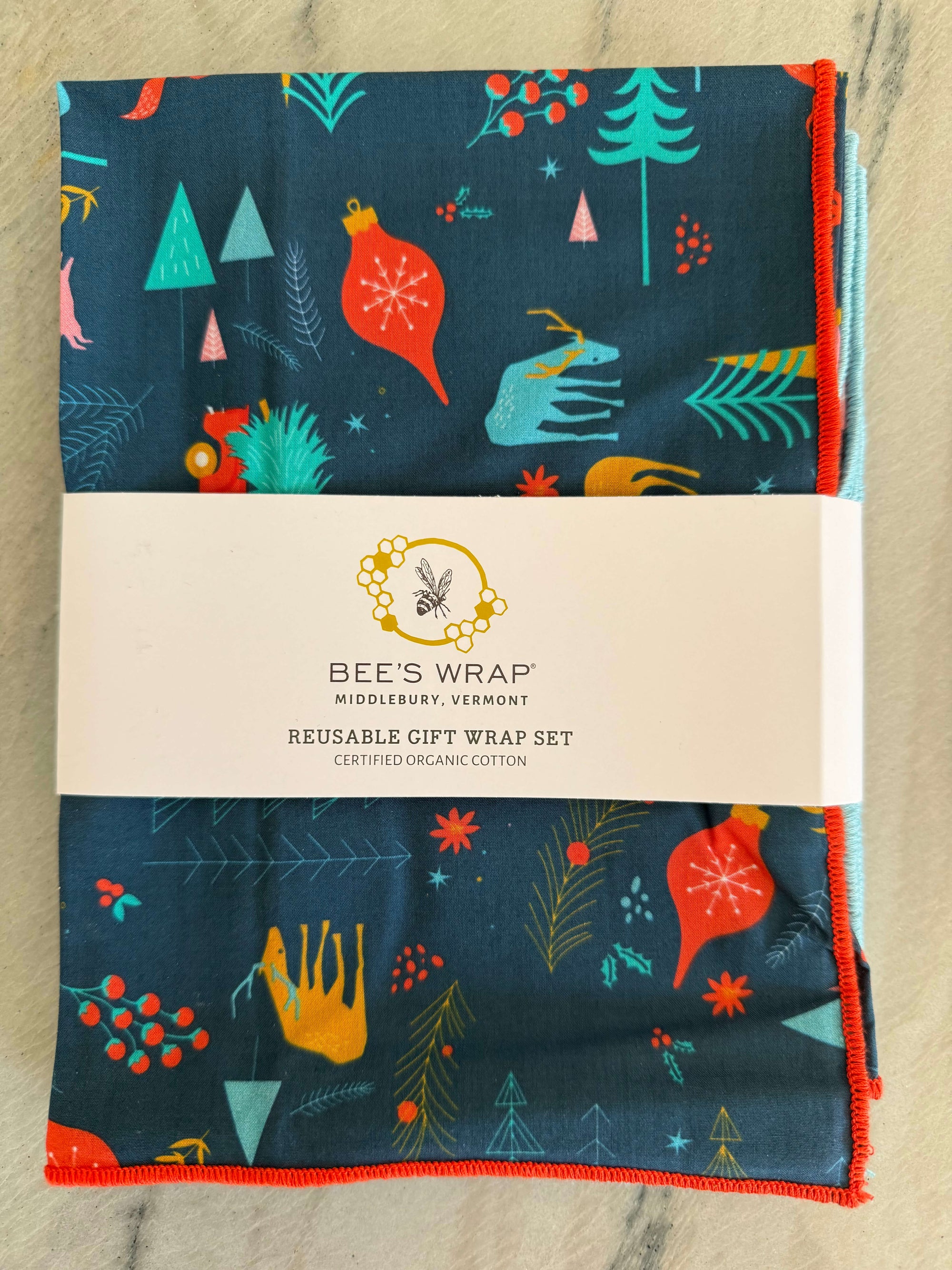 Set of 4 Reusable fabric gift wraps with holiday prints on dark blue organic cotton fabric