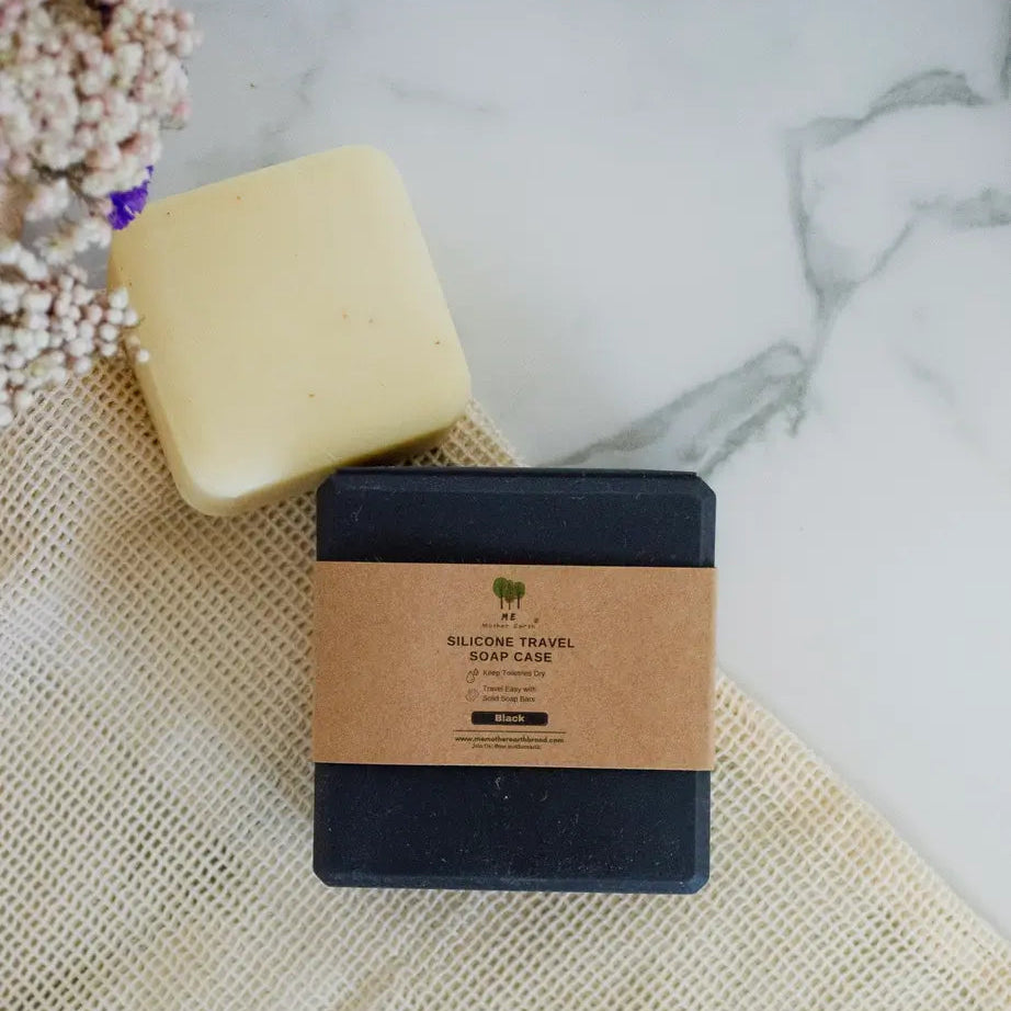 Bar of soap and silicone travel soap case on a textured surface with a blurred background
