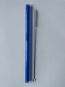 Blue glass straw and cleaning brush on a white background