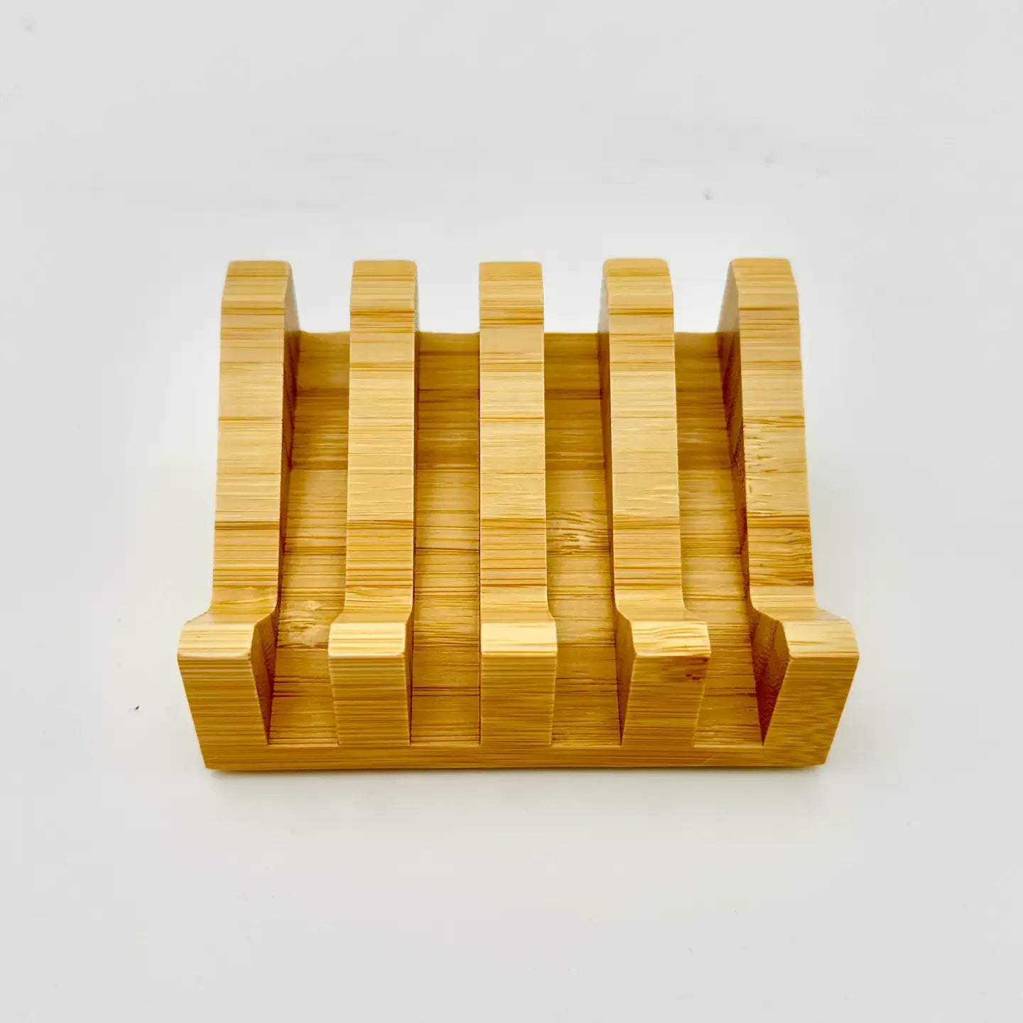 Wooden knife block with multiple slots on a white background