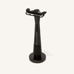 Black stand with a one blade razor on a white background