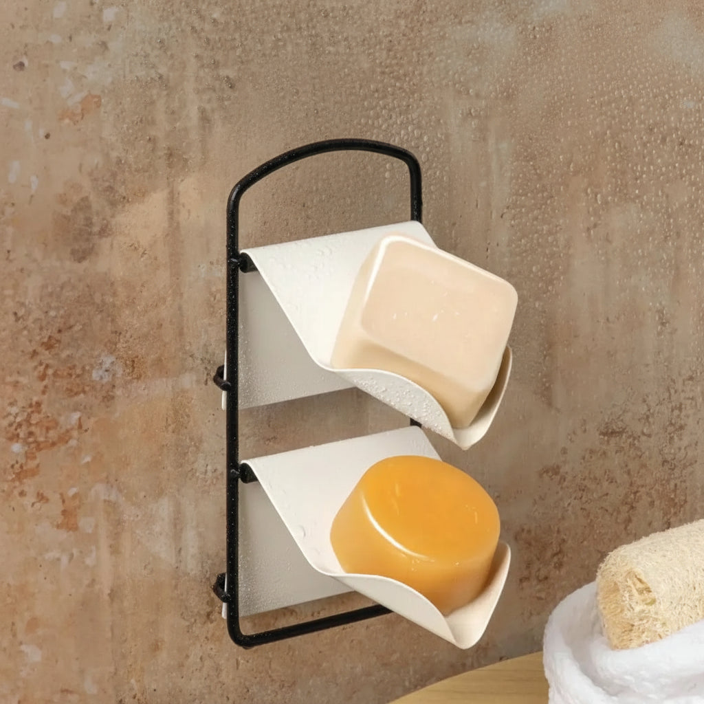 Wall-mounted soap holder with two soap bars on a textured wall background