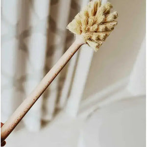 Bamboo toilet brush with natural bristle head against a neutral background