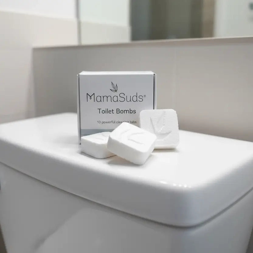 MamaSuds toilet bombs on a toilet tank lid in a bathroom setting