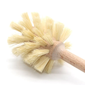 Close-up of a wooden toilet brush with natural bristles on a white background