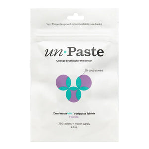 Package of unPaste zero-waste mint toothpaste tablets on a white background