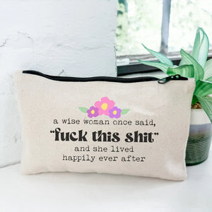 Canvas pouch with humorous quote and floral design on a white surface.