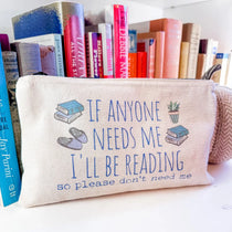 Pouch with 'If anyone needs me, I'll be reading' text among books