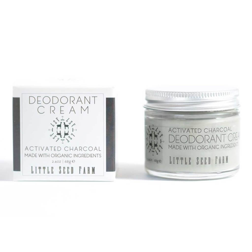 A glass jar of Activated Charcoal Deodorant Cream from Little Seed Farm and is packaging on a plain white background
