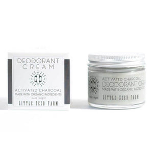A glass jar of Activated Charcoal Deodorant Cream from Little Seed Farm and is packaging on a plain white background
