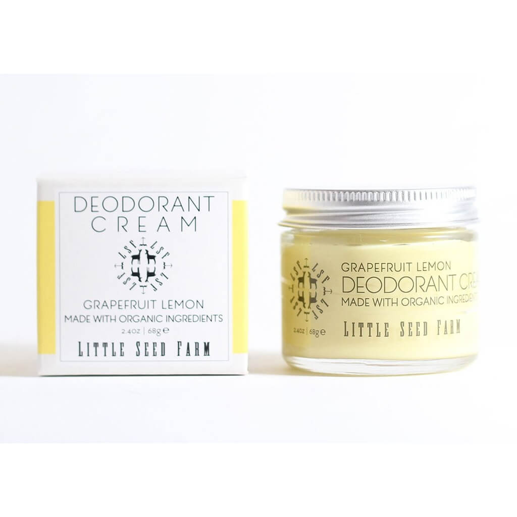 A glass jar of Grapefruit Lemon Deodorant Cream from Little Seed Farm and is packaging on a plain white background