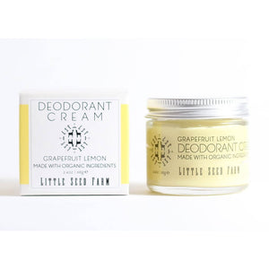 A glass jar of Grapefruit Lemon Deodorant Cream from Little Seed Farm and is packaging on a plain white background