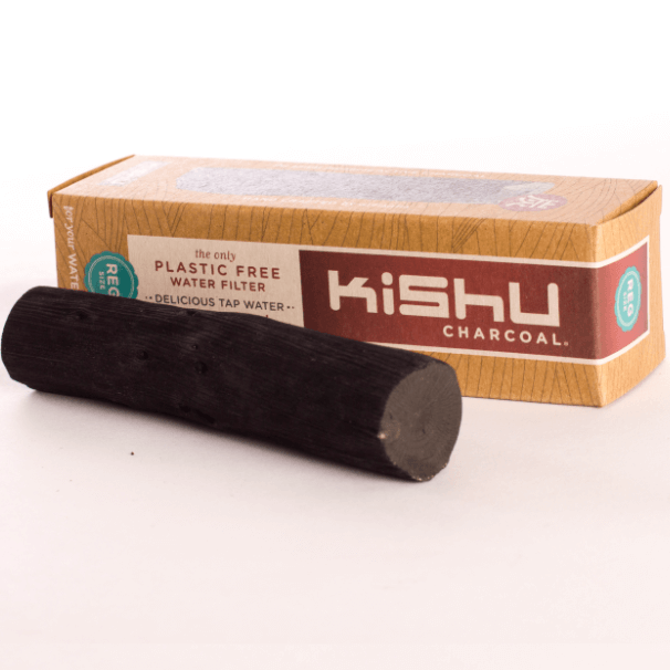 A black charcoal water filter stick next to its packaging box with 'KISHU CHARCOAL' branding.