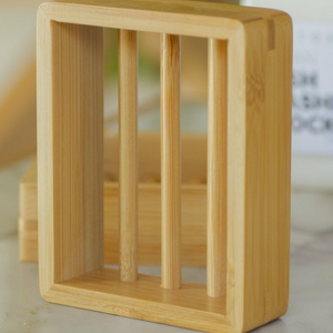 Wooden soap dish with vertical slats on a blurred background