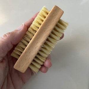 Left hand holding a nail brush