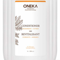 A refillable white bottle of Oneka conditioner with a label showing the brand name and the word 'CONDITIONER' in bold, and a scent option section indicating 'Citrus', 'Lavender', 'Cedar and Sage', and 'Unscented'.