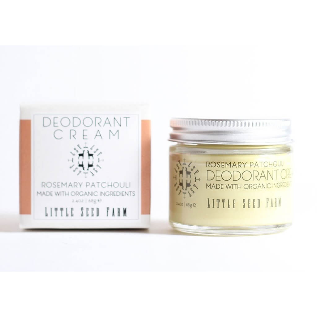 A glass jar of Rosemary Patchouli Deodorant Cream from Little Seed Farm and is packaging on a plain white background