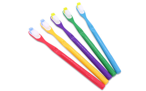 A selection of toothbrushes with replaceable heads in various colors displayed in a bathroom setting, with packaging that indicates different bristle types.