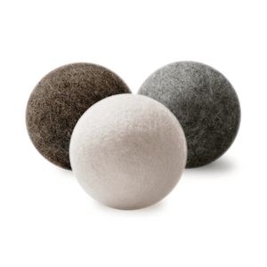Three wool dryer balls in beige, black, and gray colors, displayed on a white background.