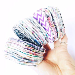 Hand holding several reusable facial rounds